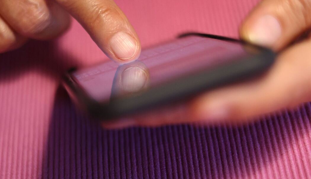 Eine Frau tippt auf einem Smartphone