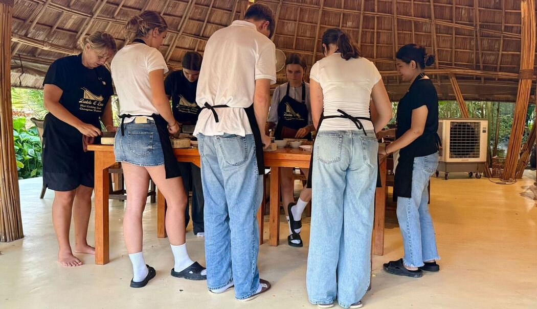 Teilnehmer kochen bei einem Kochkurs Teilnehmer kochen bei einem Kochkurs