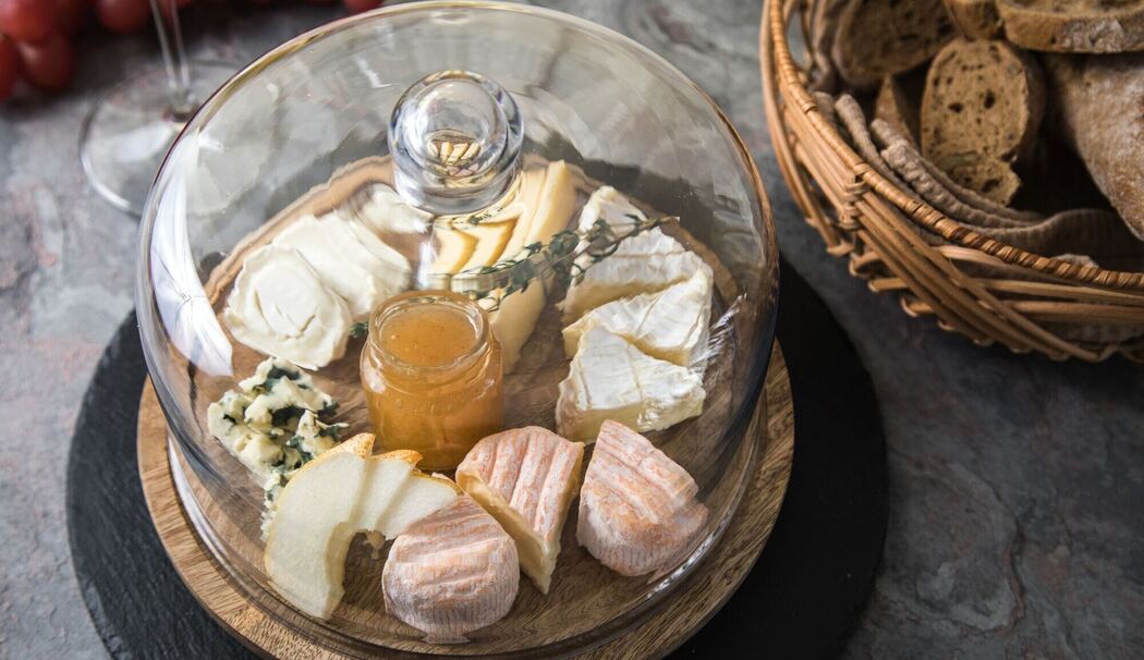 Käse wird unter einer Käseglocke aufbewahrt Käse wird unter einer Käseglocke aufbewahrt